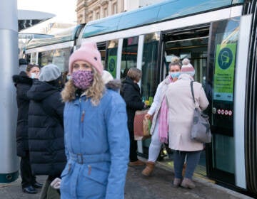 People step off a tram in Nottingham