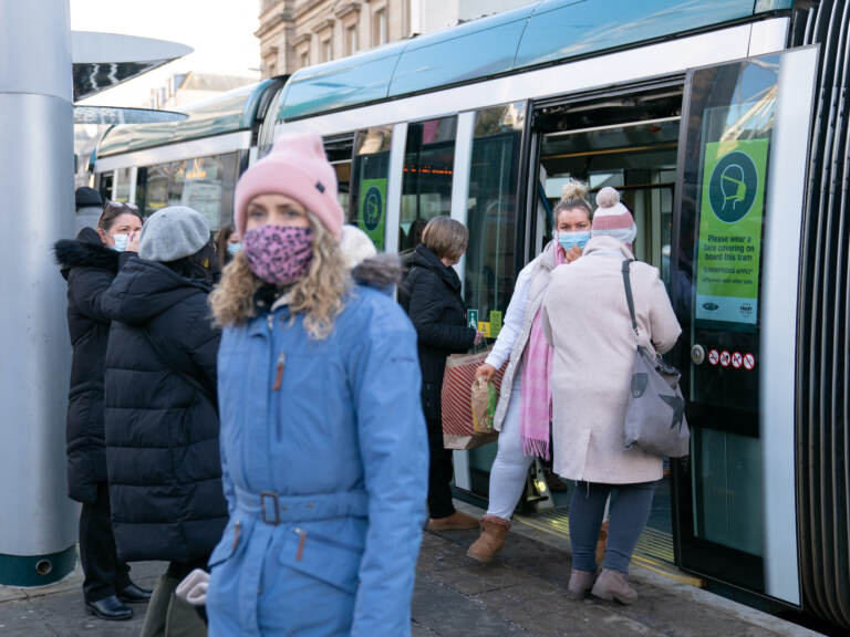 People step off a tram in Nottingham