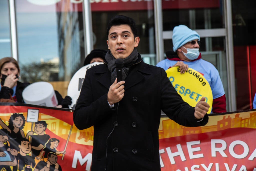 Oscar Lopez speaks during a protest from a microphone