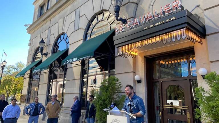 Chef Tyler Akin talks outside his restaurant Le Cavalier about plans for Wilmington restaurants to team up with celebrity chefs to raise money to support the Independent Restaurant Coalition’s efforts to help eateries damaged by the pandemic. (Mark Eichmann/WHYY)