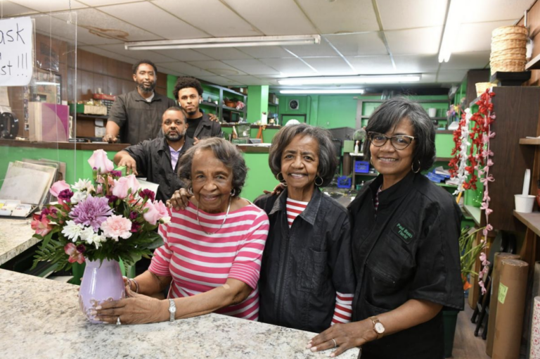 David Beale Jr. (from left), Naeem White, Paul David Beale Sr., Altermese Beale, Carolyn Beale, and Paulette Beale Harris stand in a flower show