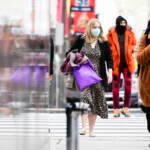 People wearing face masks walk through Philadelphia