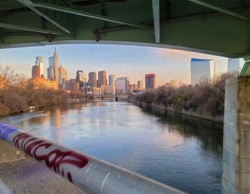 The Philadelphia skyline is seen from a bridge.