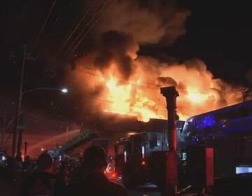 A vacant warehouse is seen aflame