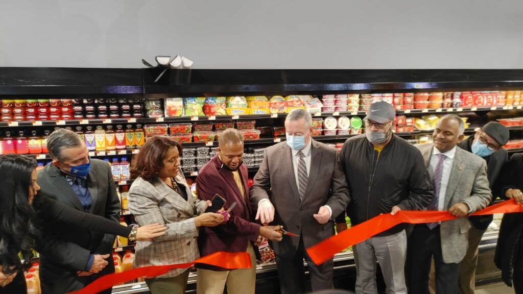 Philadelphia Mayor Jim Kenney (fifth from right) helps cut the ribbon at the new Juniata Juniata Supermarket