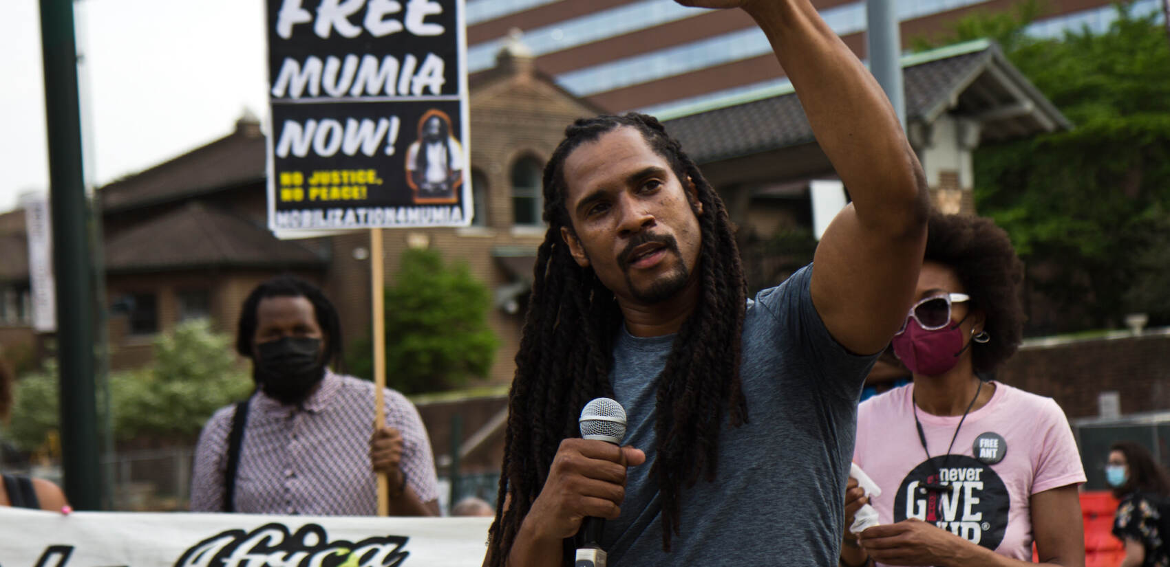 Mike Africa raises a fist at a protest