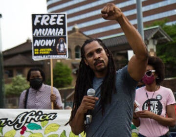 Mike Africa raises a fist at a protest