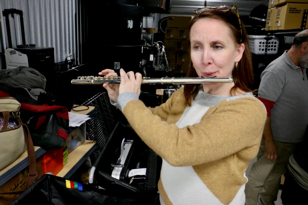 Musicopia Executive Director Catherine Charlton plays a donated flute