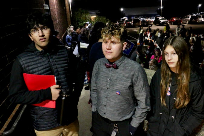 (From left) Anshul Shukla, Seth Soderquist, and Lily Freeman wait in line