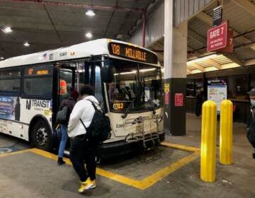 Passengers board NJ Transit Bus Route 408 to Millville at the Walter Rand Transportation Center in Camden on Dec. 10, 2021. The route operates between there and Philadelphia and Millville with a stop in Glassboro, the southern terminus of the proposed Glassboro Camden Line. (P. Kenneth Burns/WHYY)