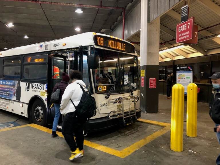 Passengers board NJ Transit Bus Route 408 to Millville at the Walter Rand Transportation Center in Camden on Dec. 10, 2021. The route operates between there and Philadelphia and Millville with a stop in Glassboro, the southern terminus of the proposed Glassboro Camden Line. (P. Kenneth Burns/WHYY)