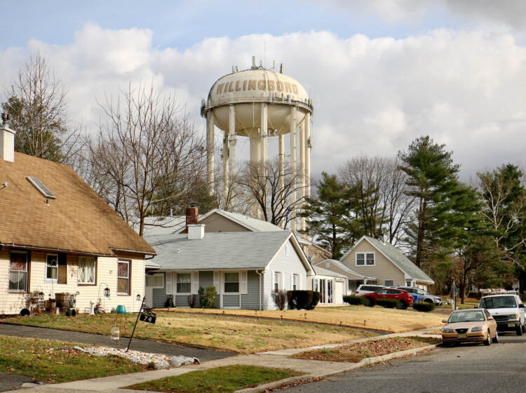 A water tower looms over the Academy Woods neighborhood
