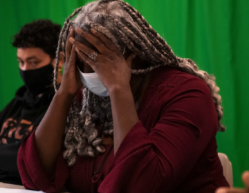 Deana Ramsey, principal at Philadelphia’s Juvenile Justice Services Center School, holds her head in frustration. Students at the school have accounted for a staggering 96 of gun violence victims last school year, the largest amount of any school in the district. (Kriston Jae Bethel for Chalkbeat)