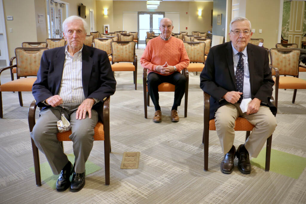 Jerry Dobbs, Fred Crotchfelt sit in chairs spaced apart