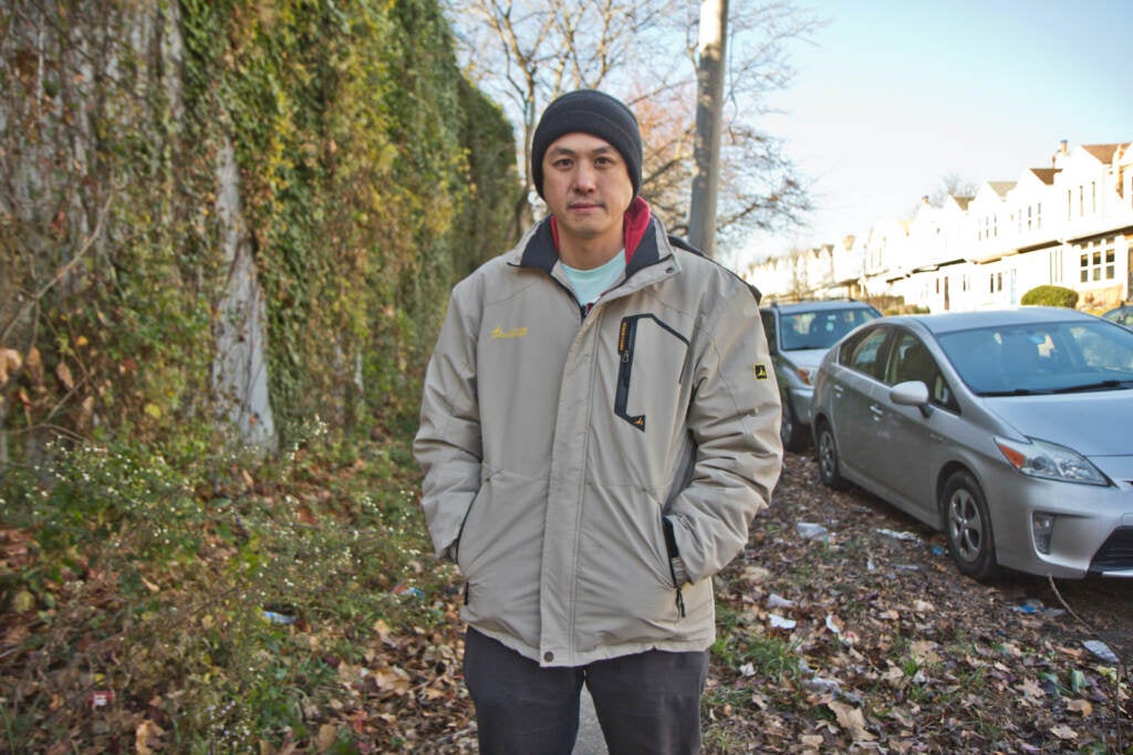Will Tung in front of a residential development at 5000 Warrington Ave.