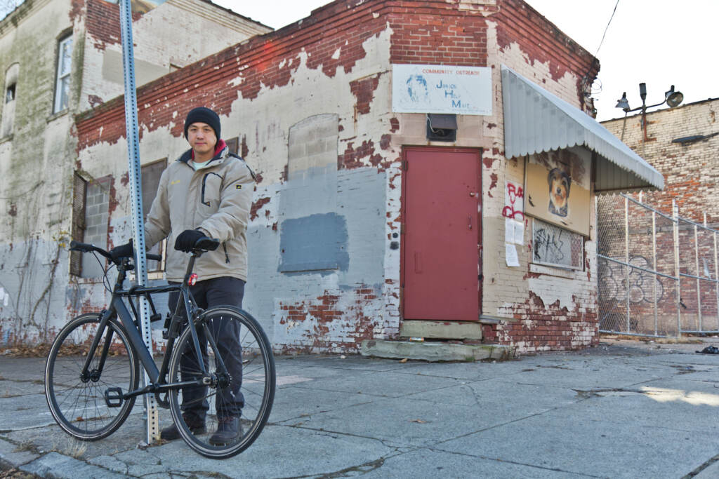 Will Tung in front of a residential development at 5000 Warrington Ave