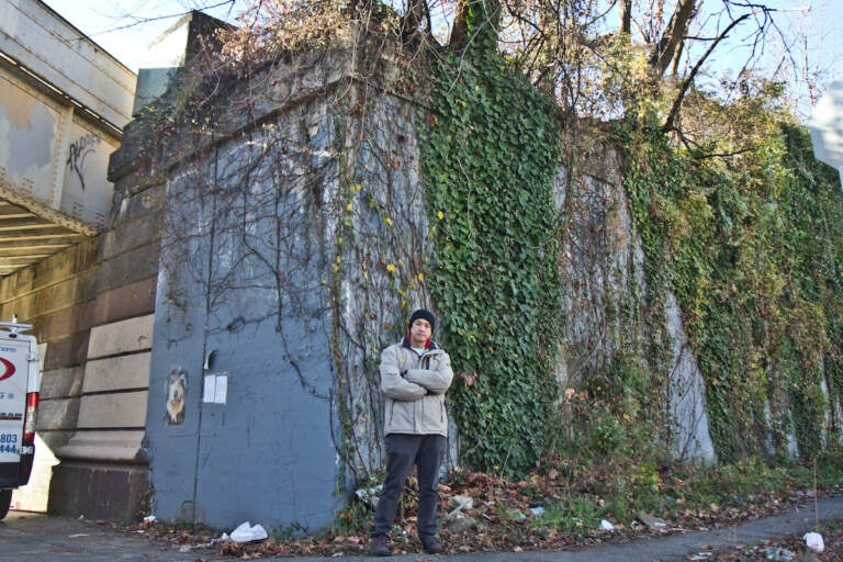 Will Tung in front of a residential development at 5000 Warrington Ave