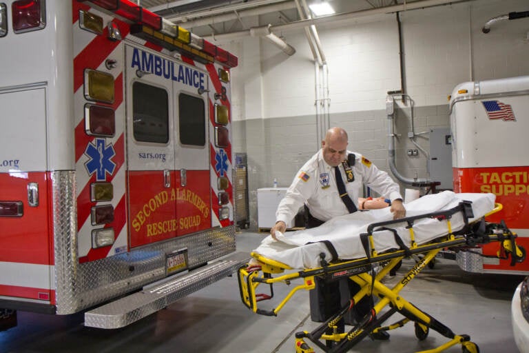 Ken Davidson arranges a stretcher