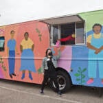 Nathalie Cerin and Colleen Hendrick stand in and outside the hygiene truck