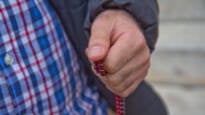 Afghan evacuee Hadi holds the prayer beads he keeps with him in his pocket