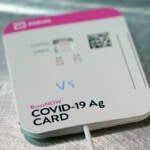 A BinaxNOW rapid COVID-19 test made by Abbott Laboratories rests on a table in the room where student-athletes at Pacific Lutheran are tested three times a week, Wednesday, Feb. 3, 2021, in Tacoma, Wash.