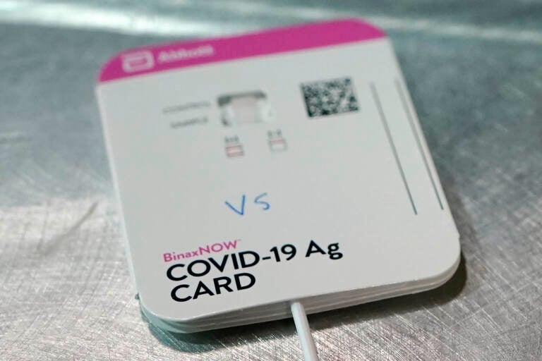 A BinaxNOW rapid COVID-19 test made by Abbott Laboratories rests on a table in the room where student-athletes at Pacific Lutheran are tested three times a week, Wednesday, Feb. 3, 2021, in Tacoma, Wash.