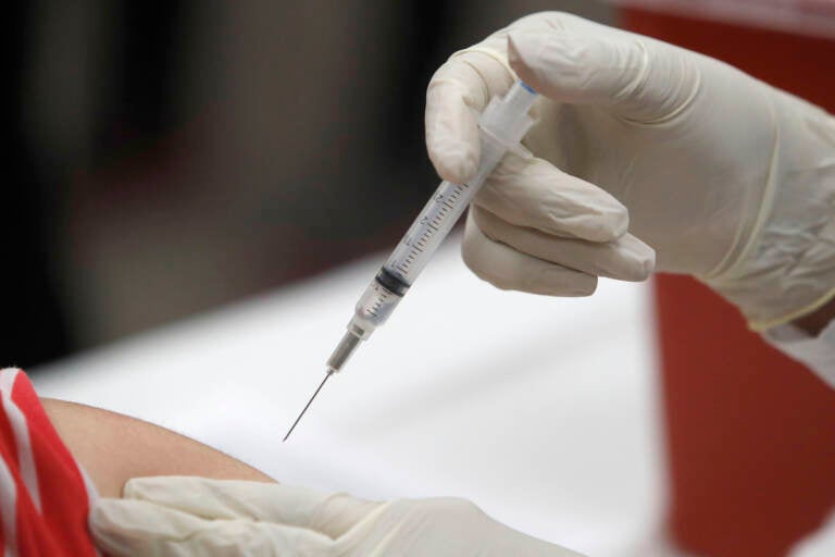 A syringe with an influenza vaccine inside heads to its mark during a flu vaccination at Eastfield College in Mesquite, Texas, Thursday, Jan. 23, 2020. This flu season started early and all but two states reported widespread outbreaks by the week ended Jan. 11, according to the U.S. Centers for Disease Control and Prevention. From 1982 to 2018, the flu most often peaked in February, so there's a good chance the rest of the states will see their cases increase this year