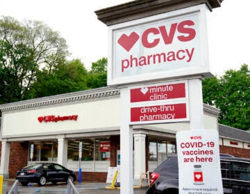 Vehicles are parked in front of a CVS Pharmacy in Mount Lebanon, Pa., on Monday May 3, 2021. CVS Health will close hundreds of drugstores over the next three years, as the retail giant adjusts to changing customer needs and converts to new store formats. The company said Thursday, Nov. 18, that it will close about 300 stores a year for the next three years as it looks to reduce store count density in some locations.