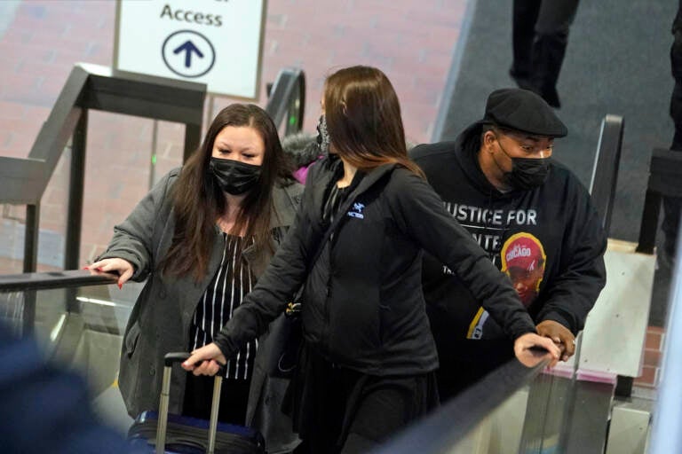 Katie Wright, the mother of Daunte Wright, left, and his father, Arbuey Wright, right, arrive Thursday, Dec. 2, 2021 at the Hennepin County Government Center in Minneapolis for the third day of jury selection for former suburban Minneapolis police officer Kim Potter, who says she meant to grab her Taser instead of her handgun when she shot and killed motorist Daunte Wright. (AP Photo/Jim Mone)