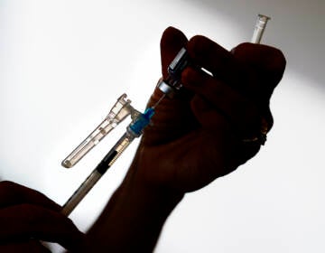 A syringe is prepared with the Pfizer COVID-19 vaccine at a clinic in the Norristown Public Health Center in Norristown, Pa., Tuesday, Dec. 7, 2021