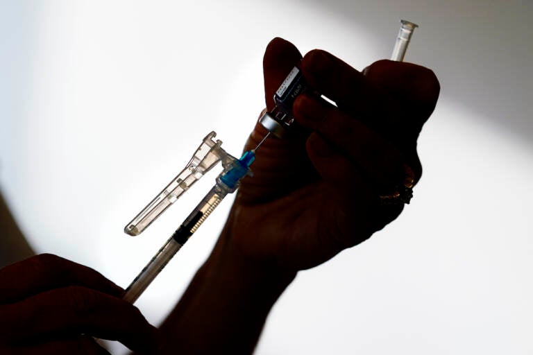 A syringe is prepared with the Pfizer COVID-19 vaccine at a clinic in the Norristown Public Health Center in Norristown, Pa., Tuesday, Dec. 7, 2021