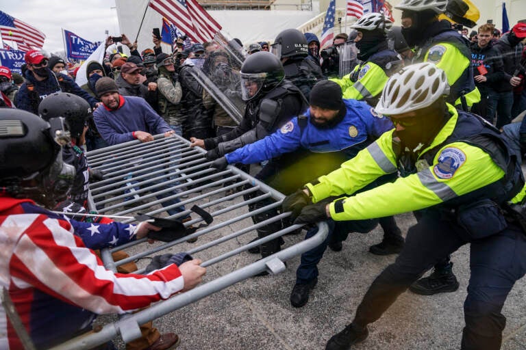 FILE - Rioters try to break through a police barrier at the Capitol in Washington, on Jan. 6, 2021. Egged on by soon-to-be former President Donald Trump, a crowd of demonstrators demanded that the electoral vote counting be stopped. (AP Photo/John Minchillo, File)