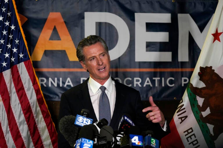 California Gov. Gavin Newsom addresses reporters, after beating back the recall that aimed to remove him from office, at the John L. Burton California Democratic Party headquarters in Sacramento, Calif., Tuesday, Sept. 14, 2021.  The recall election that once threatened Newsom’s political career has instead given it new life, The rare mid-term vote of confidence could fuel an ambitious legislative agenda featuring new corona virus vaccine mandates, housing for the homeless and health insurance for people living in the country illegally. (AP Photo/Rich Pedroncelli)