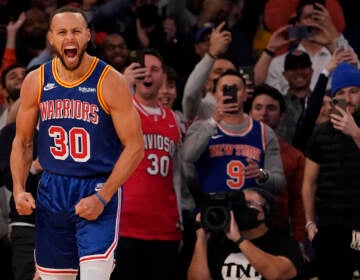 Golden State Warriors guard Stephen Curry reacts after scoring a 3-point basket during the first half of an NBA basketball game against the New York Knicks, Tuesday, Dec. 14, 2021, at Madison Square Garden in New York. Curry hit his 2,974th 3-pointer Tuesday night in the first quarter, breaking the record set by Ray Allen.