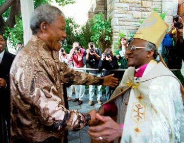 FILE — Retiring Archbishop of Cape Town Desmond Tutu, right, greets President Nelson Mandela at a service in Cape Town, Sunday June 23, 1996 held to celebrate the end of Tutu's tenure as leader of the Anglican Church in South Africa. (AP Photo / Guy Tillim/File)