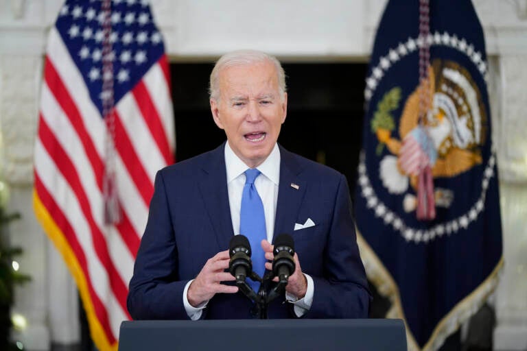 President Joe Biden speaks from a podium