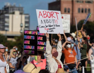 FILE - People attend the Women's March ATX rally, Saturday, Oct., 2, 2021, at the Texas State Capitol in Austin, Texas.  An expected decision by the U.S. Supreme Court in the coming year to severely restrict abortion rights or overturn Roe v. Wade entirely is setting off a renewed round of abortion battles in state legislatures. (AP Photo/Stephen Spillman, File)