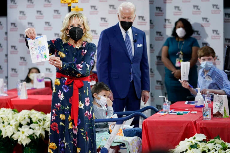 First Lady Jill Biden displays a lantern made by a patient at Children's National Hospital as part of a winter craft project as she and President Joe Biden visit patients in Washington, Friday, Dec. 24, 2021.