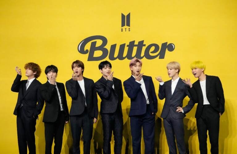 Members of South Korean K-pop band BTS, V, SUGA, JIN, Jung Kook, RM, Jimin, and j-hope from left to right, pose for photographers ahead of a press conference to introduce their new single 