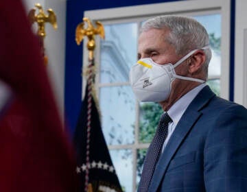 Dr. Anthony Fauci, the top U.S. infectious disease expert, wears a face mask as he arrives for the the White House COVID-19 Response Team's regular call with the National Governors Association in the South Court Auditorium in the Eisenhower Executive Office Building on the White House Campus, Monday, Dec. 27, 2021, in Washington. Fauci says the U.S. should consider a vaccination mandate for domestic air travel as coronavirus infections surge. To date the Biden administration has balked at the idea, anticipating legal entanglements. (AP Photo/Carolyn Kaster)