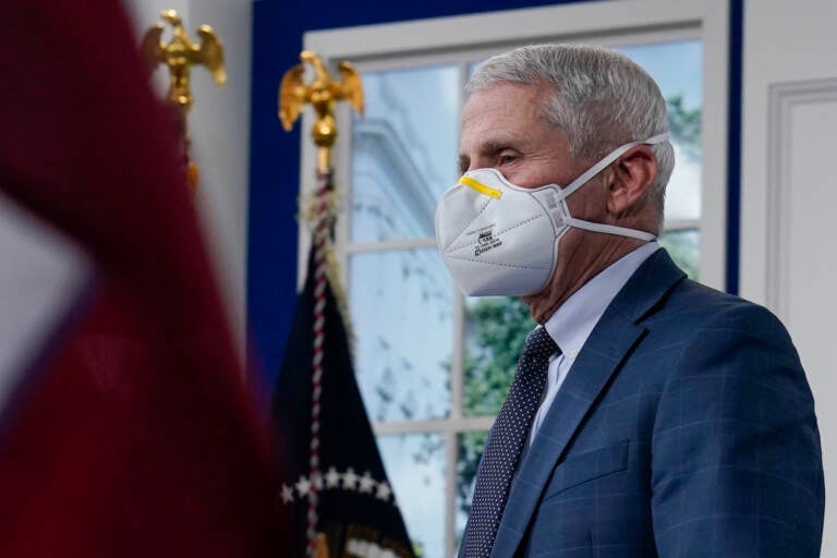 Dr. Anthony Fauci, the top U.S. infectious disease expert, wears a face mask as he arrives for the the White House COVID-19 Response Team's regular call with the National Governors Association in the South Court Auditorium in the Eisenhower Executive Office Building on the White House Campus, Monday, Dec. 27, 2021, in Washington. Fauci says the U.S. should consider a vaccination mandate for domestic air travel as coronavirus infections surge. To date the Biden administration has balked at the idea, anticipating legal entanglements. (AP Photo/Carolyn Kaster)