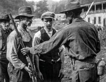After the Battle of Blair Mountain in 1921, union miners surrendered their weapons. (Wikimedia Commons)