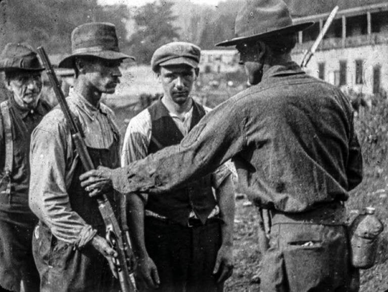 After the Battle of Blair Mountain in 1921, union miners surrendered their weapons. (Wikimedia Commons)