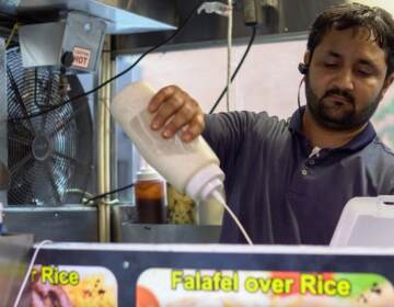 Aamir Khan, who runs a cart at 33rd and Market streets, is glad students are back NOEL CHACKO, JACOB SMOLLEN, KAVEEN HAROHALLI