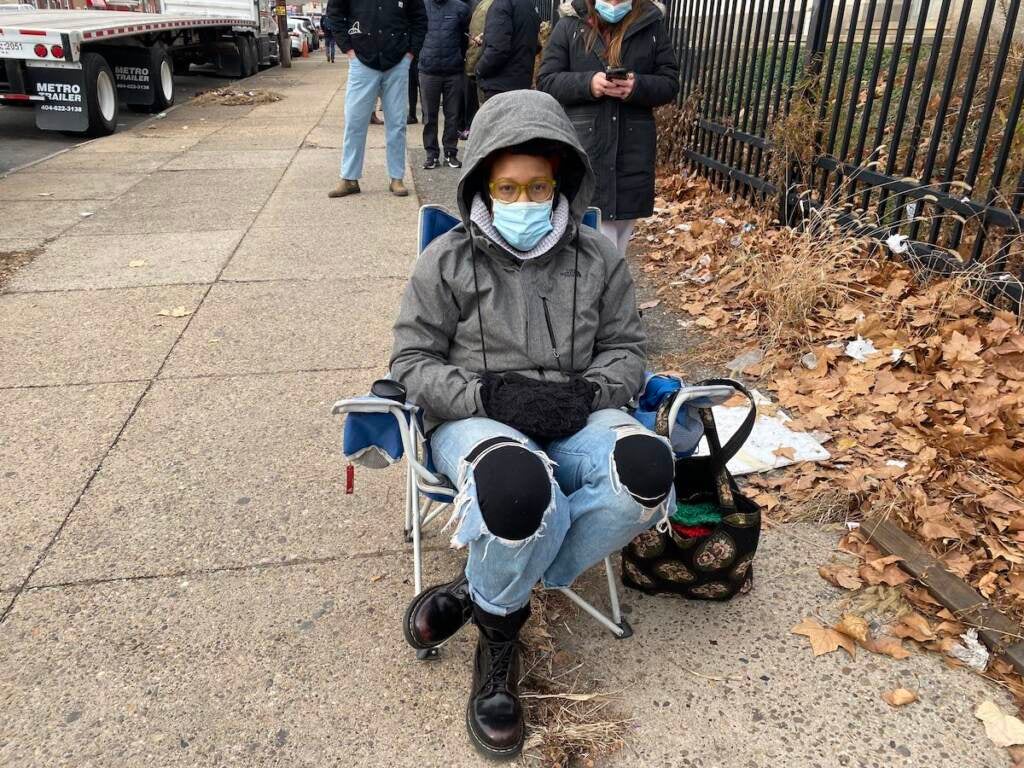 Crystal Thomas waits outside Lillian Marrero Library for rapid at-home Covid test kits. ''I've been to so many pharmacies. You can't even rob somebody for a test at this point.'' (Liz Tung/WHYY)