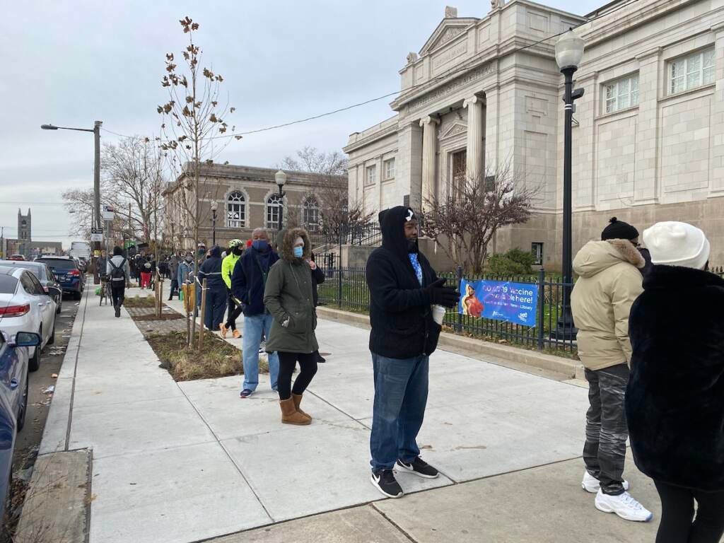 More than 300 people lined up outside the Lillian Lillian Marrero Library on Tuesday in hopes of getting their hands on free at-home Covid test kits, being distributed by the city. (Liz Tung/WHYY)