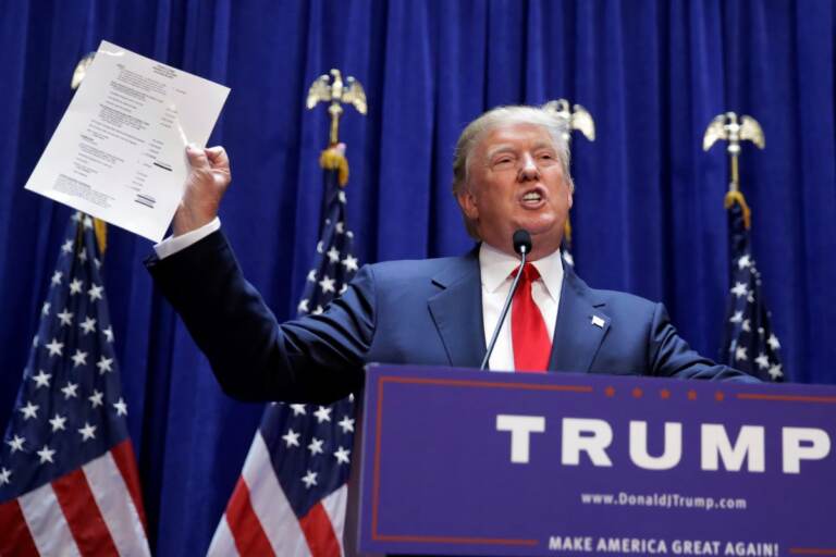 (Donald Trump displays a copy of his net worth during his announcement that he will seek the Republican nomination for president, Tuesday, June 16, 2015, in the lobby of Trump Tower in New York. (AP Photo/Richard Drew)