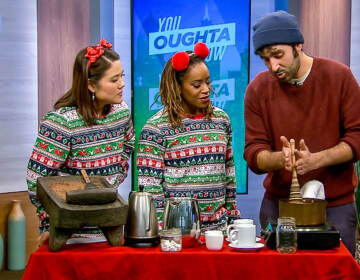 Shirley and Regina wearing Christmas pajamas making hot chocolate with someone from Shane Confectionery