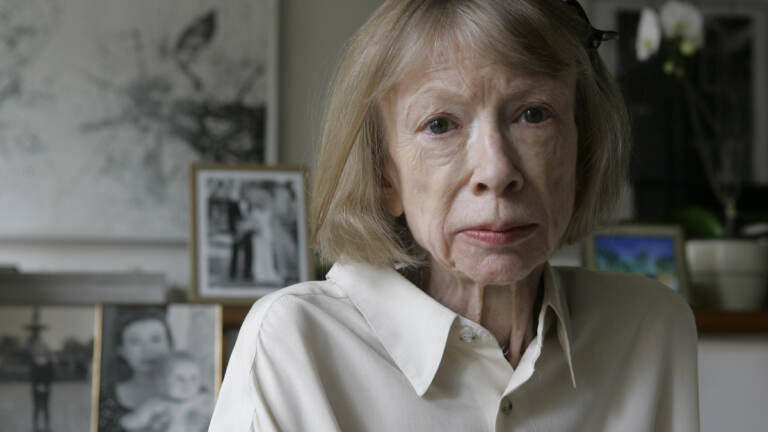 Author Joan Didion sits in front of a photo of herself holding her daughter, Quintana Roo Dunne, and another photo of her daughter’s wedding. Didion wrote about her daughter’s death at age 39 in Blue Nights. Author Joan Didion sits in front of a photo of herself holding her daughter, Quintana Roo Dunne, and another photo of her daughter's wedding. Didion wrote about her daughter's death at age 39 in Blue Nights.
(Kathy Willens/AP)