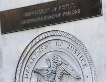 In this July 6, 2020, file photo a sign for the Department of Justice Federal Bureau of Prisons is displayed at the Metropolitan Detention Center in the Brooklyn borough of New York. While most criminal justice overhauls require action from local officials or legislation, reforming the federal prison system is something President Joe Biden and his Justice Department control. (AP Photo/Mark Lennihan, File)